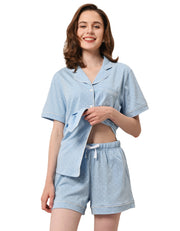 Light blue polka dot print women’s knit cotton pajama set with short sleeve top and shorts on white background