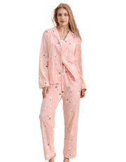 Pink Christmas women’s knit cotton pajama set with animal silhouette print front view on white background