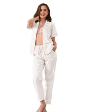 White knit cotton women’s pajama set with pink piping front view on white background