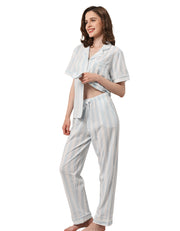 Women’s light blue vertical stripe cotton pajama set with short sleeve button-down top and long pants on white background